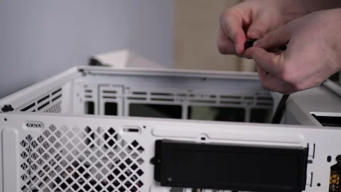 Man builds personal desktop computer, technician assembles components into case. Stock Footage 129026129