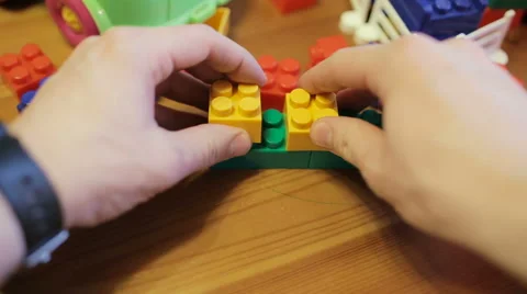 Man builds the shape of children's blocks, first-person view Video stock 61380823