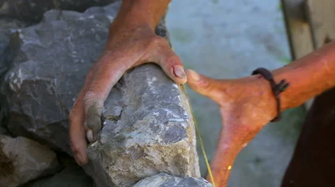 Man builds the stone wall with his hands Video stock 48016320