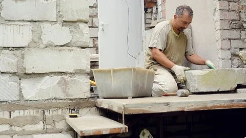 A man builds a wall at home Stock Footage 112505942