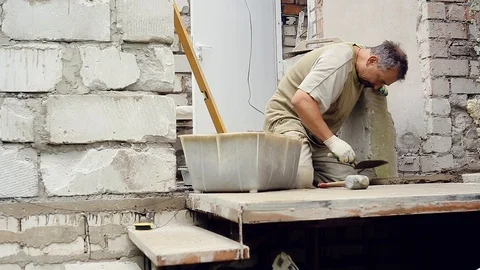 A man builds a wall at home Stock Footage 112506336