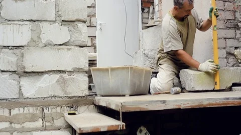 A man builds a wall at home Stock Footage 112507555