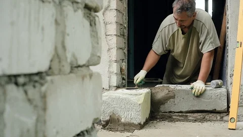 A man builds a wall at home Stock Footage 112801052