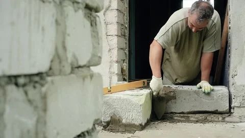 A man builds a wall at home Stock Footage 147594628