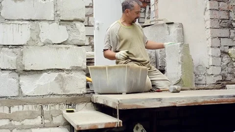 A man builds a wall at home Stock Footage 147595165