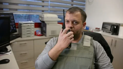 Man in bulletproof vest in security room. selective focus, Stock Footage 172364868