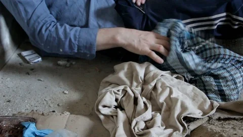 A man of a bum grabs a dirty rag Stock Footage 89574624
