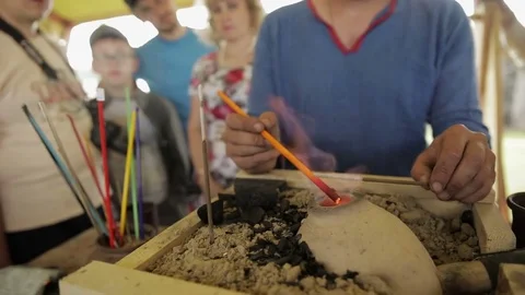 Man burns plastic on fire Stock Footage 82359428