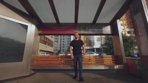 A man at the bus stop in the morning Stock Footage 249533459