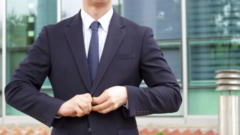 Man in a business suit buttoning his jacket close-up. Stock Footage 153121735