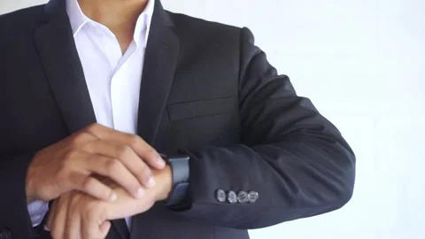 A man in a business suit checking a smart watch on his hand Stock Footage 322159678