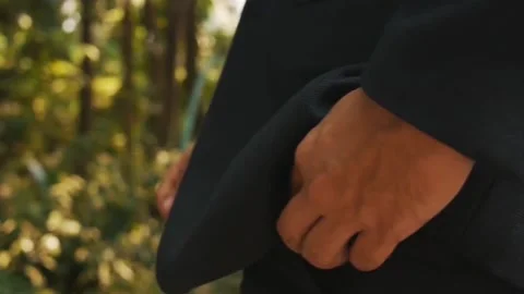 A man in a business suit puts his hand in his trouser pocket. Wedding. Close up Stock Footage