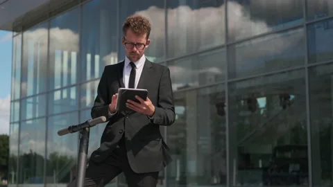 Man in business suit is using tablet, checking e-mail Video stock 143906498
