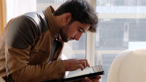 Man busy with a touch screen handheld electronic device working online through w Stock-Footage 101286118