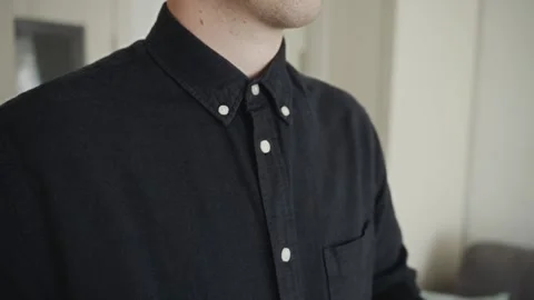 Man in buttoned shirt standing confidently indoors Video stock 317553548