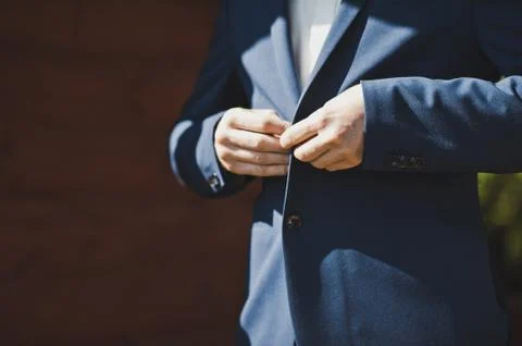 The man buttoning the buttons of his jacket  Stock Photos