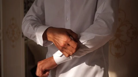 Man buttoning buttons on sleeves in white shirt Stock Footage 127430964