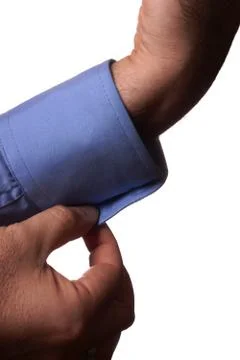 Man buttoning a cuff Stock Photos