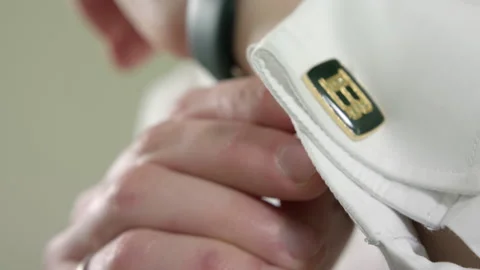 Man buttoning a cufflink on his shirt sleeve Stock Footage 160436627