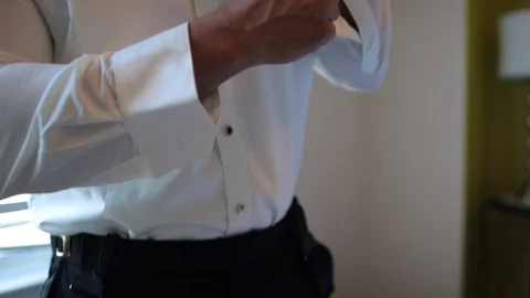 Man buttoning cufflinks in slowmotion 動画素材 100722683