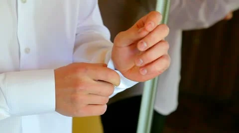 Man buttoning cuffs Stock Footage 10897772