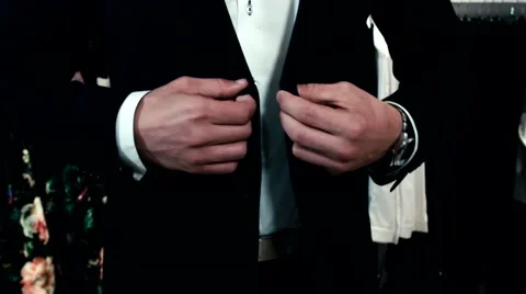 Man buttoning his jacket Stock Footage 55330577