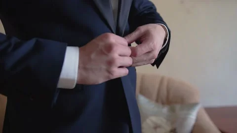 A man is buttoning his jacket going to a meeting. Side-by-side close-up 動画素材 222643278