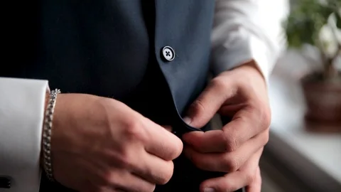 Man is buttoning his vest. Men's beauty, fashion. Stock Footage 105902432