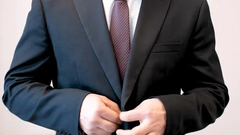 Man buttoning jacket close-up front view. Stock Footage 304401845