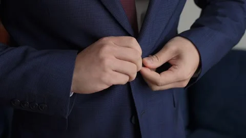 Man Buttoning Navy Suit Jacket Closeup Hands Adjusting Tie, Poised Professional Stock Footage 323773576