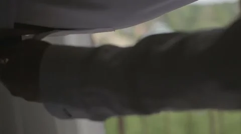 Man buttoning shirt cuff Stock Footage 56574213