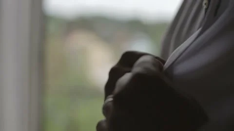 Man buttoning shirt Stock Footage 56574603