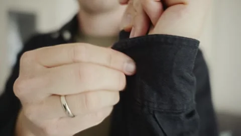 Man buttoning sleeve close-up as part of daily preparation Stock Footage 316578813