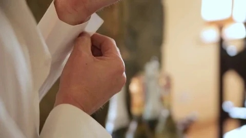 Man buttoning on the sleeve of his shirt. Zip up the cufflink. Men's style Stock Footage 82199776