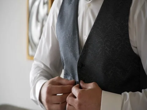 Man buttoning the vest close-up Video stock 81543235