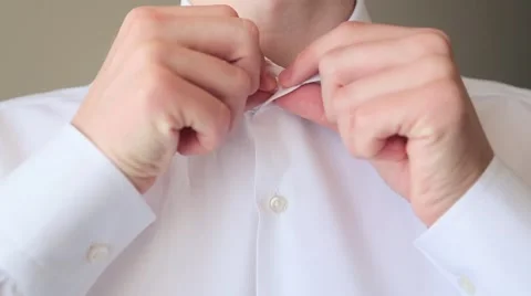 Man buttoning white shirt close-up Stock-Footage 64916913