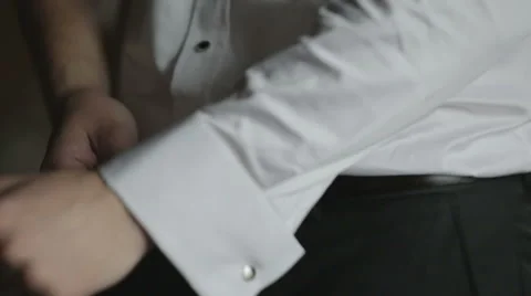 Man buttoning white shirt cuff  Stock Footage 58008041