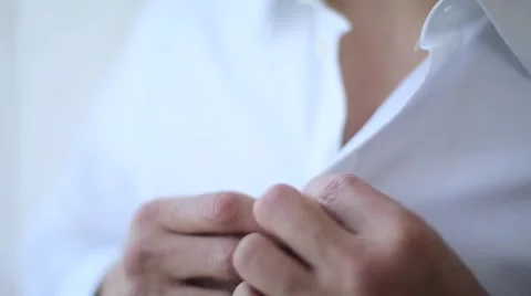 Man buttoning a white shirt Stock Footage 61925493