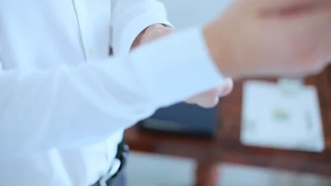 Man buttoning a white shirt Stock Footage 71890971