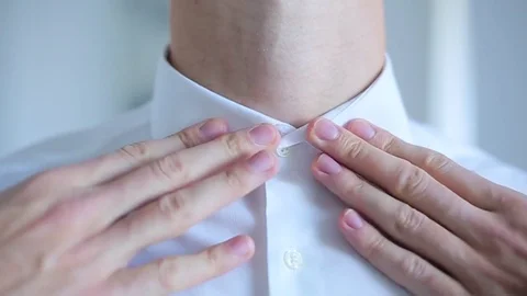 Man buttoning a white shirt Stock Footage 71891164
