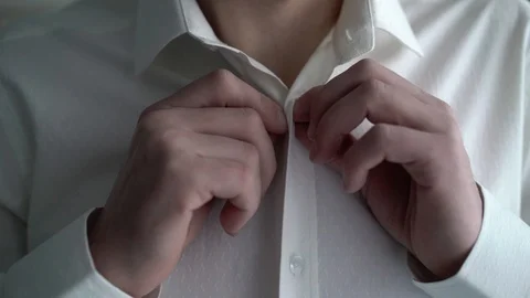 Man buttoning white shirt Stock Footage 87719809
