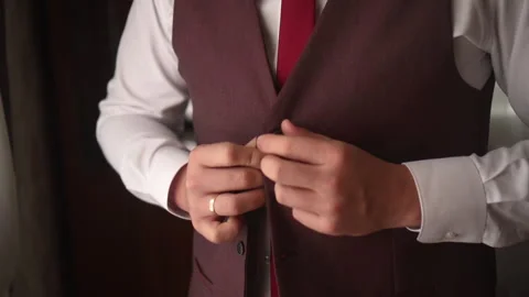 A man buttons up a beautiful jacket Stock Footage 166921547