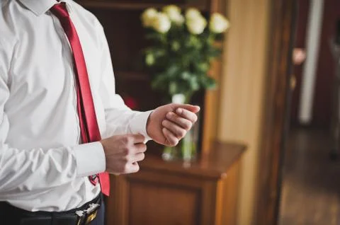 Man buttons button on the sleeve white shirts 8032. Stock Photos