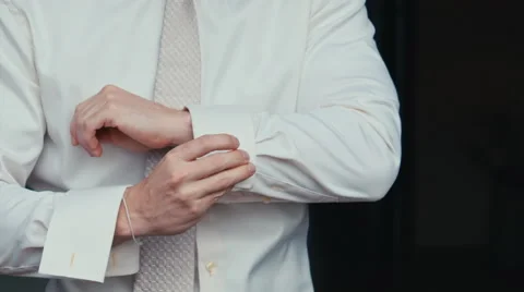 Man buttons cuff link on the shirt Stock Footage 68142732