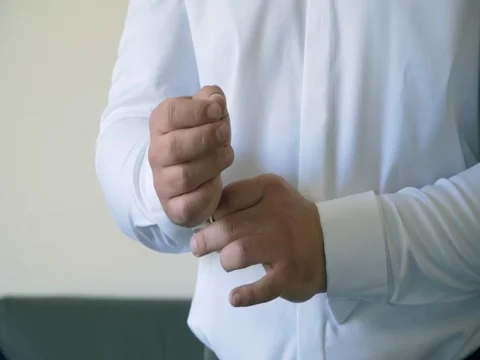 Man buttons cuff link on the shirt 스톡 동영상 78612502