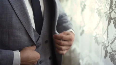 Man buttons on gray jacket Stock Footage 168313613