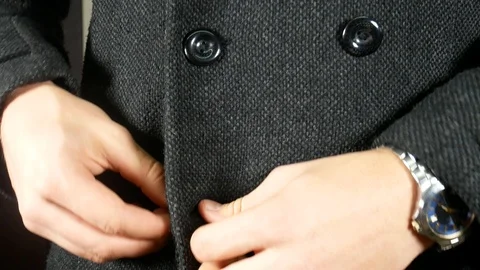 Man buttons his gray winter coat Stock Footage 119104621