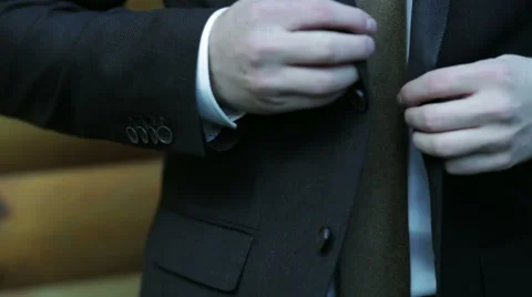 Man buttons his jacket close-up Stock Footage 60008520