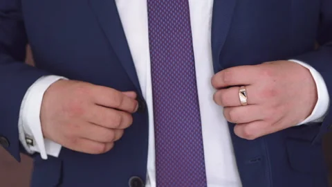 A man buttons up his jacket Stock Footage 167467701