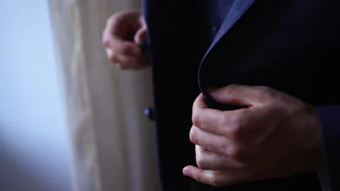 A man buttons up his new jacket. Stock Footage 154314015